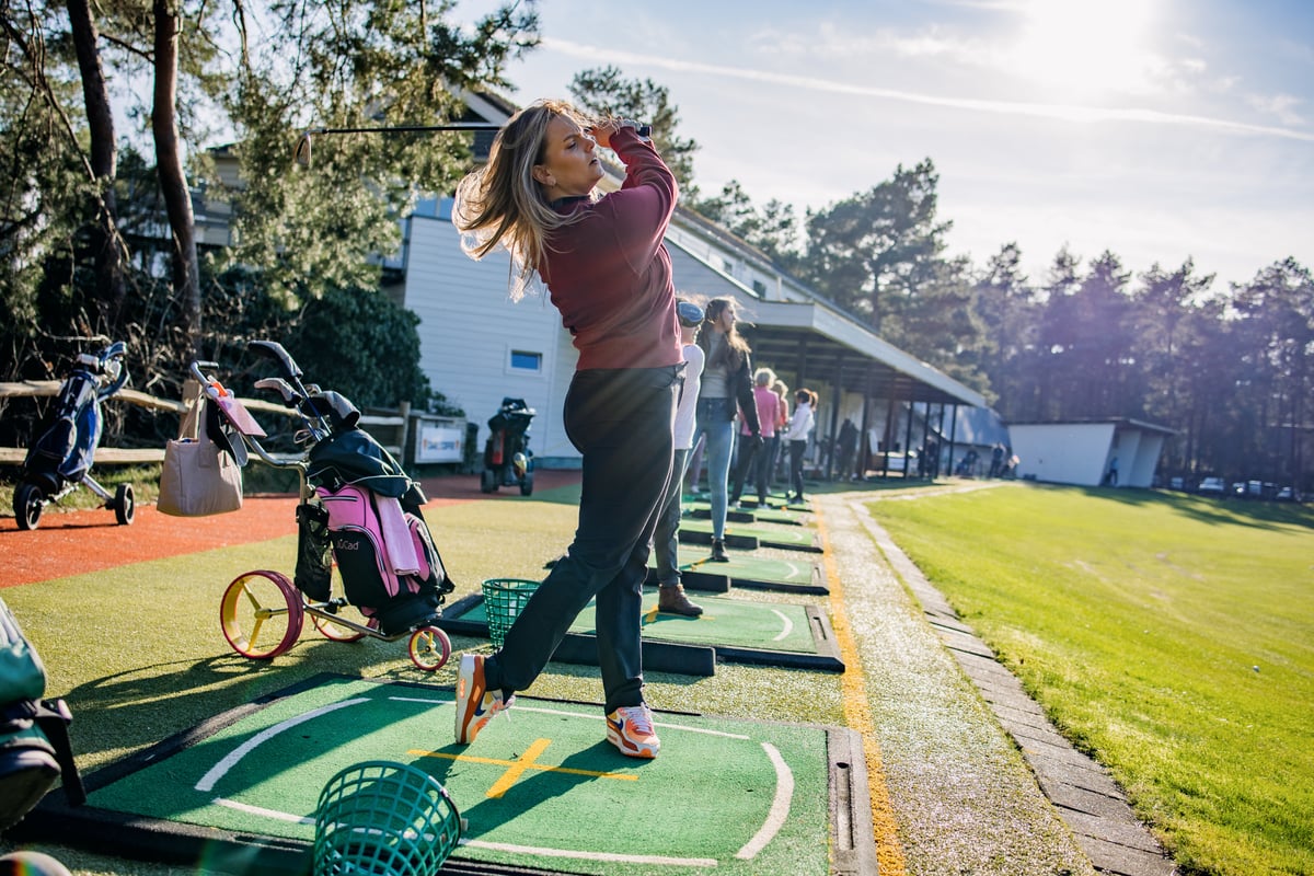 Female golfer swinging a club. Photo_ Renate Roeleveld